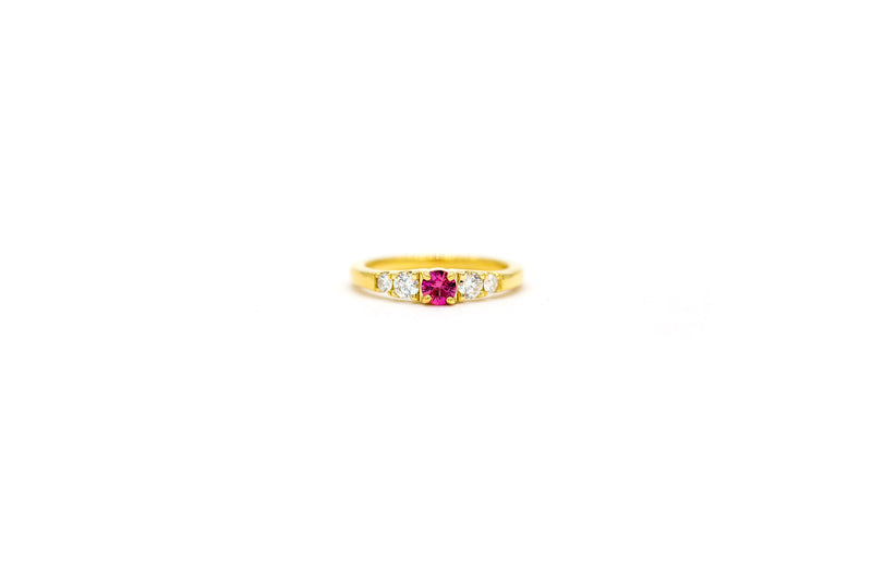 18k yellow gold pinky ring featuring a 0.30 carat round ruby...